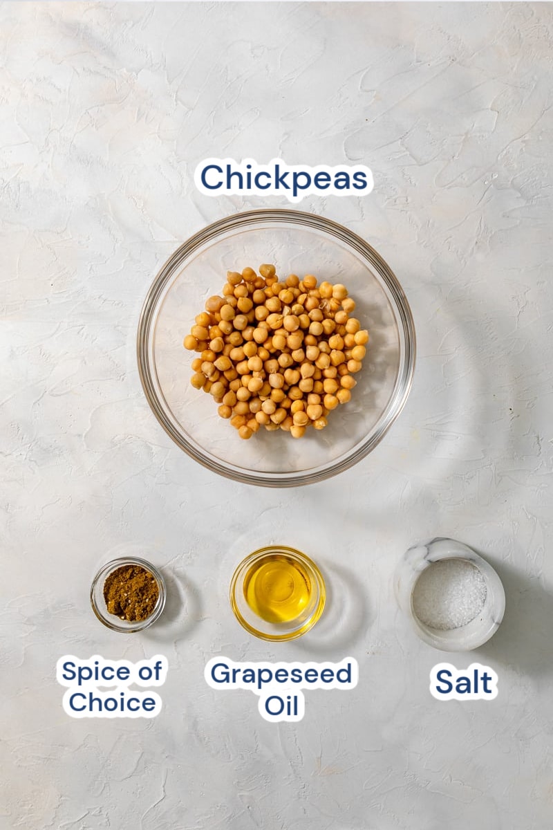 ingredients in glass bowl - chickpeas, zataar, olive oil, salt.