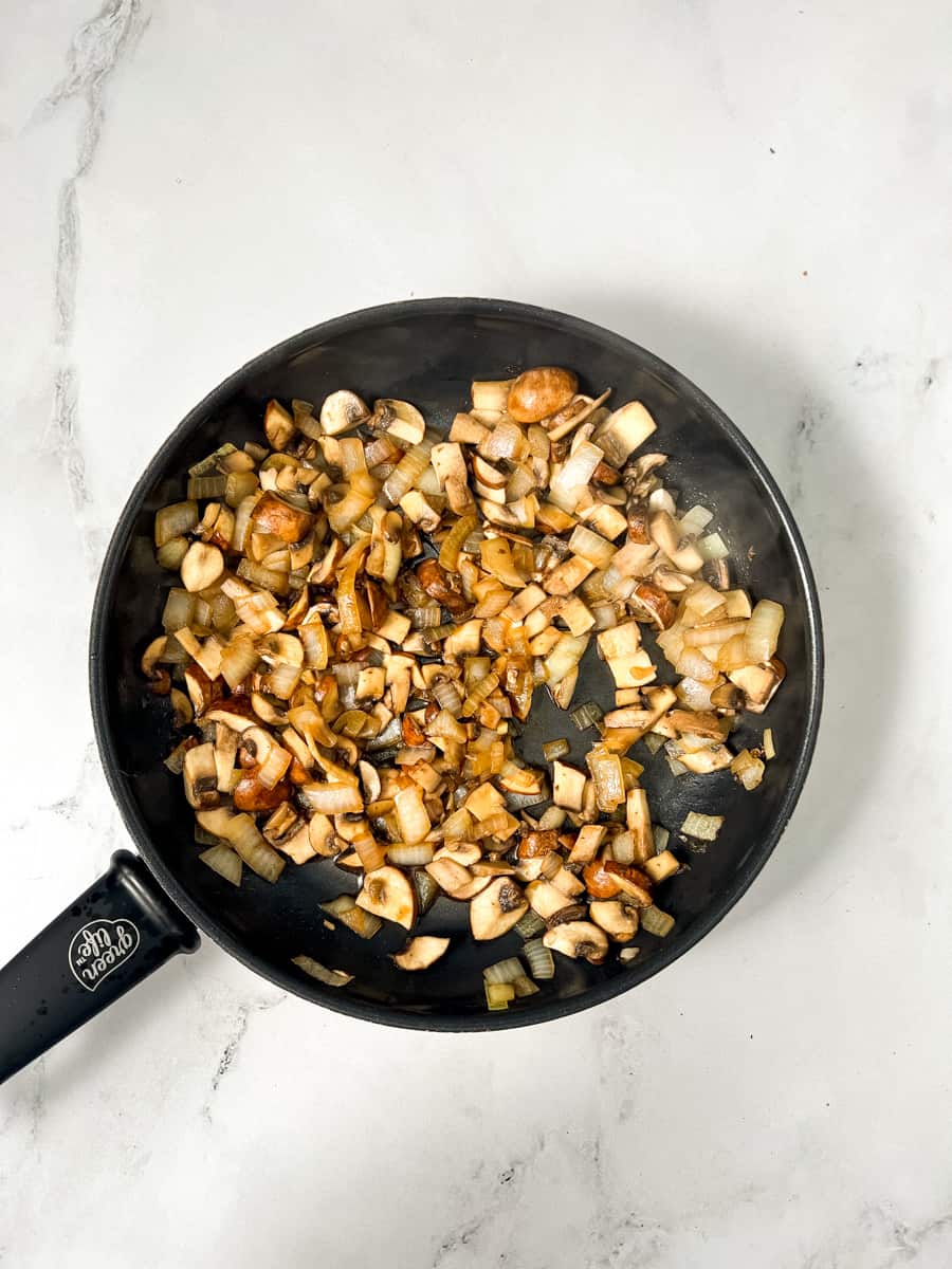 softened mushrooms and onions in a nonstick frying pan