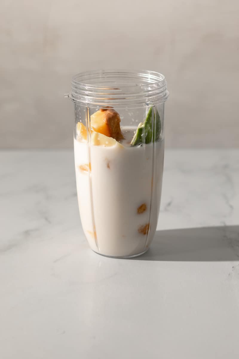 personal blender filled ¾ of the way with coconut milk.