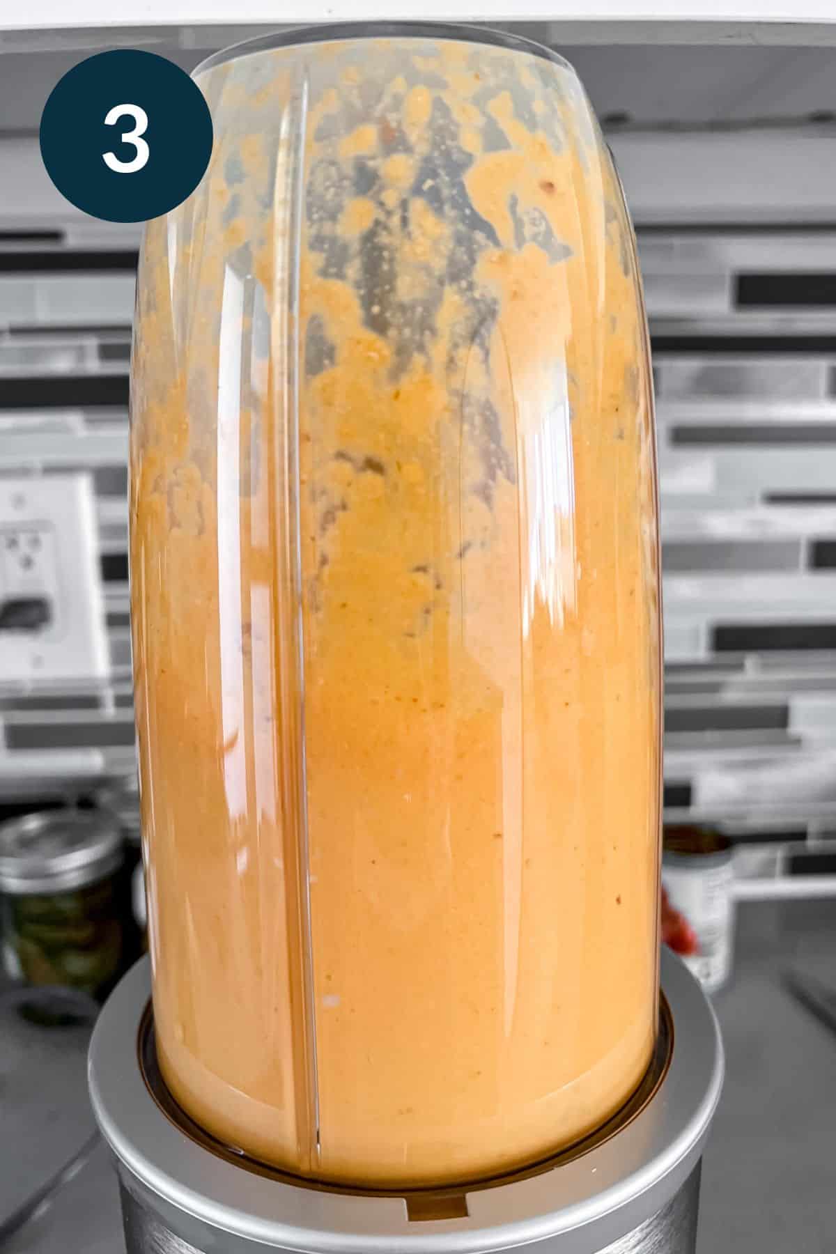 personal blender with smooth orange/yellow cashew cream sauce. 